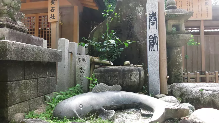 Pierre de poisson-chat devant le sanctuaire Kanameishi