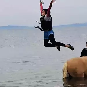 playing in the sea with horses